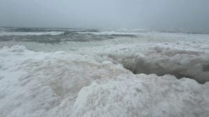 Giant waves of ice crash along Lake Michigan shore during life-threatening blizzard