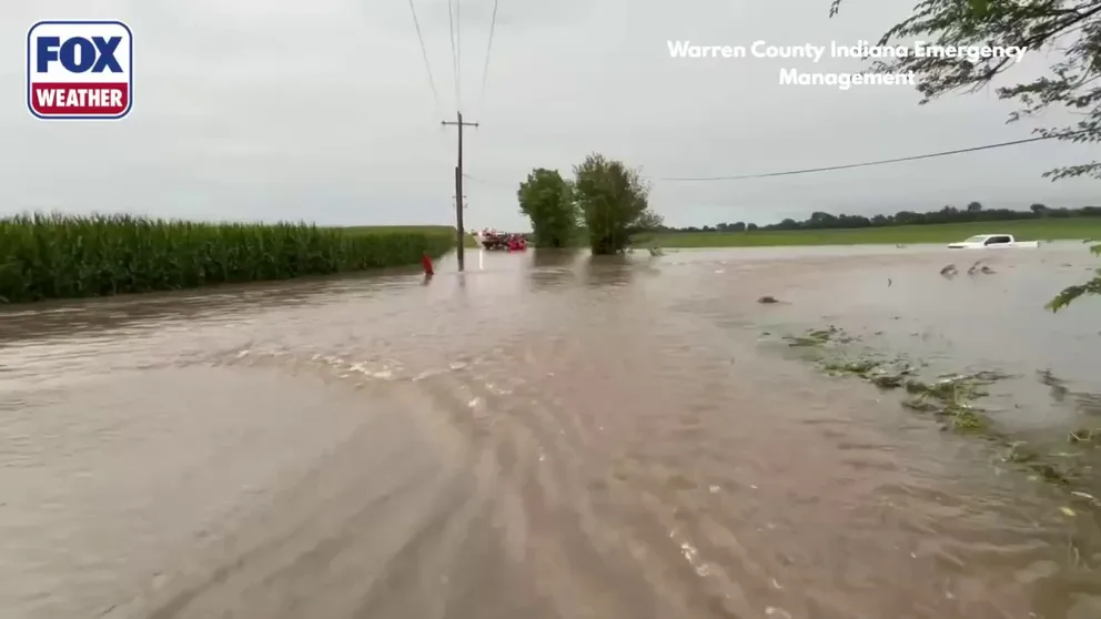 Video from Friday morning shows a water rescue team at a flooded intersection in Warren County, Indiana, after a truck attempted to drive into floodwaters an was pushed off the road into a field needing rescue. 