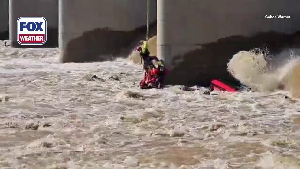 After a rescue boat capsized near a dam on Lake Springfield in Springfield, Missouri, members of the Springfield Fire Department were forced to rappel from a bridge to save a young girl from the raging waters below. The devastating incident claimed the lives of two people, left one person missing, and sent three rescuers to the hospital. Dramatic footage captures the high-risk rescue effort as emergency crews raced against the powerful current.