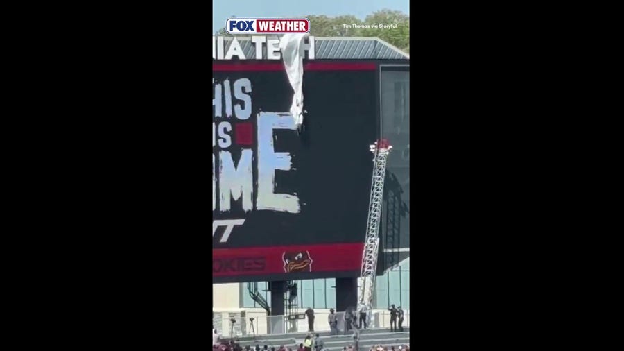 Skydiver becomes stuck against scoreboard at Lane Stadium in Virginia
