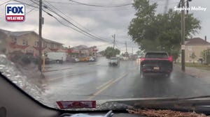 Cars drive through minor street flooding in New Jersey