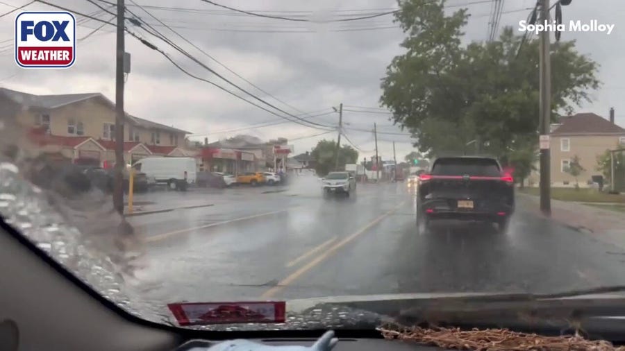 Cars drive through minor street flooding in New Jersey