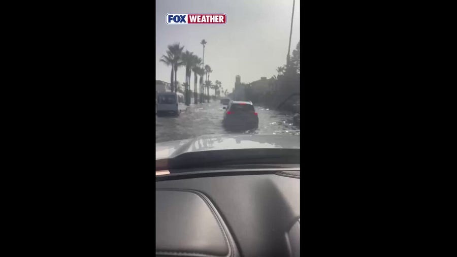 See it: Vehicles drive through flooded streets of Newport Beach, California, as Tropical Storm Rachel nears West Coast