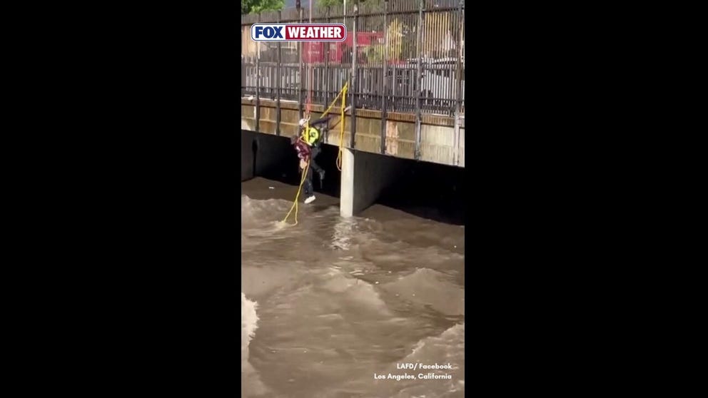 Three people were pulled from the rain-swollen Pacoima Wash in North Hills, California, after fast-moving floodwaters swept through the channel.