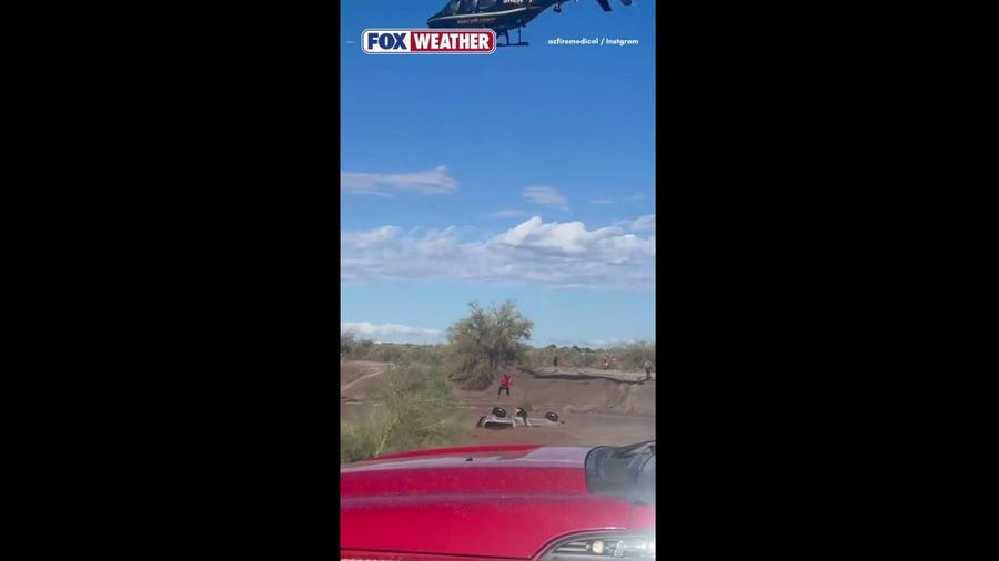 Stranded driver in floodwaters rescued by helicopter