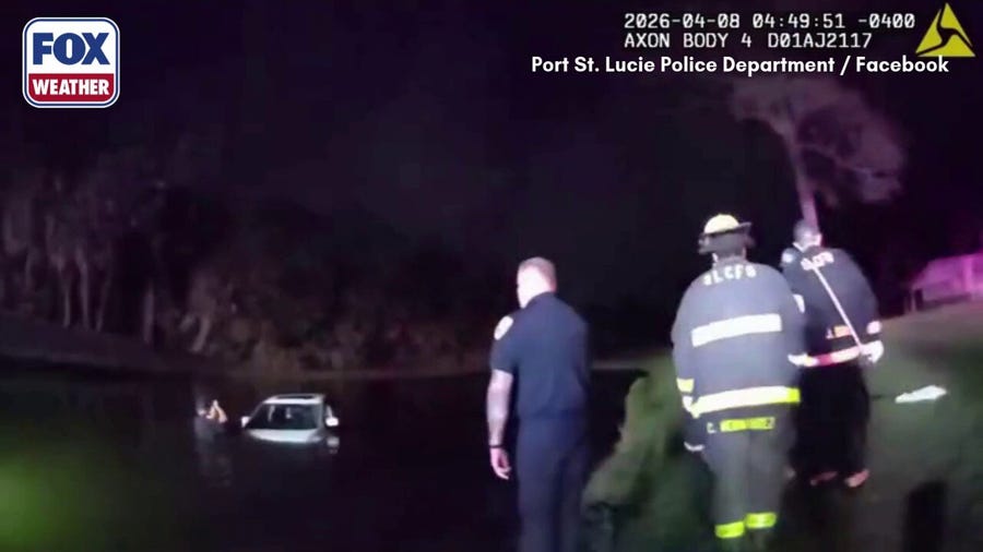 Watch: Police rescue elderly couple from partially submerged vehicle in Port St. Lucie 