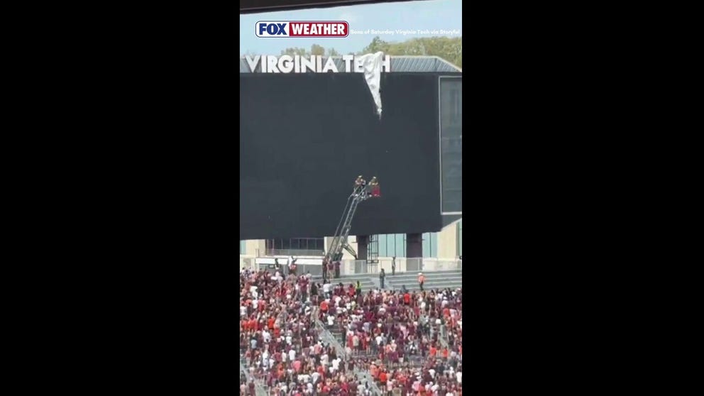 Members of the Blacksburg Volunteer Fire Department rescued a parachuter who crashed into a scoreboard and became stuck at Lane Stadium for Virginia Tech's spring football game on Saturday.