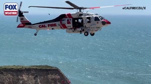 Rescue crews respond after a driver plunges off a cliff in California