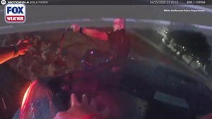 Mother, two children rescued after car swept into floodwaters