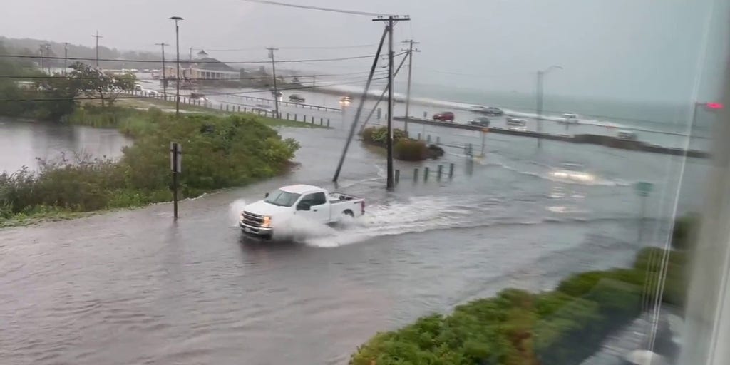 Cars travel through flooded roadways near Rhode Island beach | Latest ...