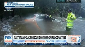 Australia police save trapped driver from floodwaters
