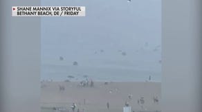 Wind tosses beach umbrellas in Delaware