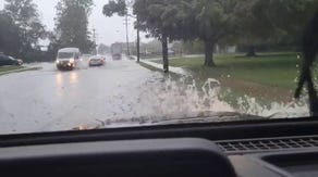 Drivers attempt to move through floodwaters in Maryland