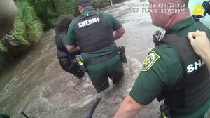 Watch: Police rescue woman trapped in surging waters