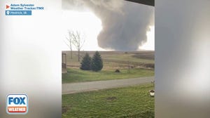 Large tornado tears across farmland in rural Iowa