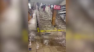 Water gushes down subway stairs during flooding in Brooklyn