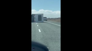 Watch: Car evades being crushed by wind toppled motorhome