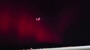 Aurora lights up sky as plane takes off from Argentina airport