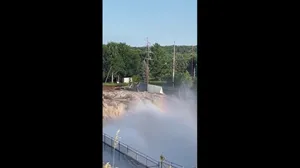 Watch: Swollen Minnesota river pull building off shore and send it downriver