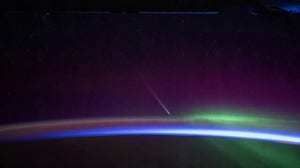 NASA astronaut photographs comet shooting by Earth from space station