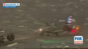 Planes wait for de-icing amid heavy lake-effect snow at Rochester International Airport