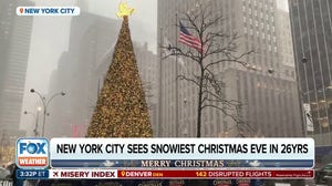 Light snow falls in New York City on Christmas Eve