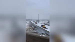 Missouri Department of Transportation trucks plow snow-covered Kansas City roads