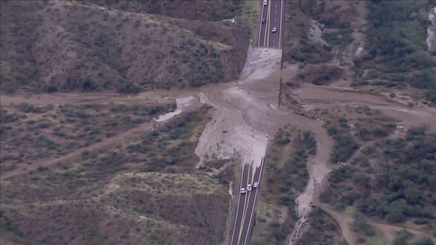 Flooding rains wash over road near Phoenix 