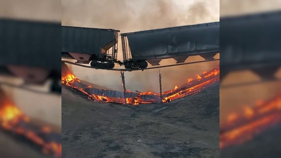 Train suspended over burning railroad bridge after grassfires in Kansas