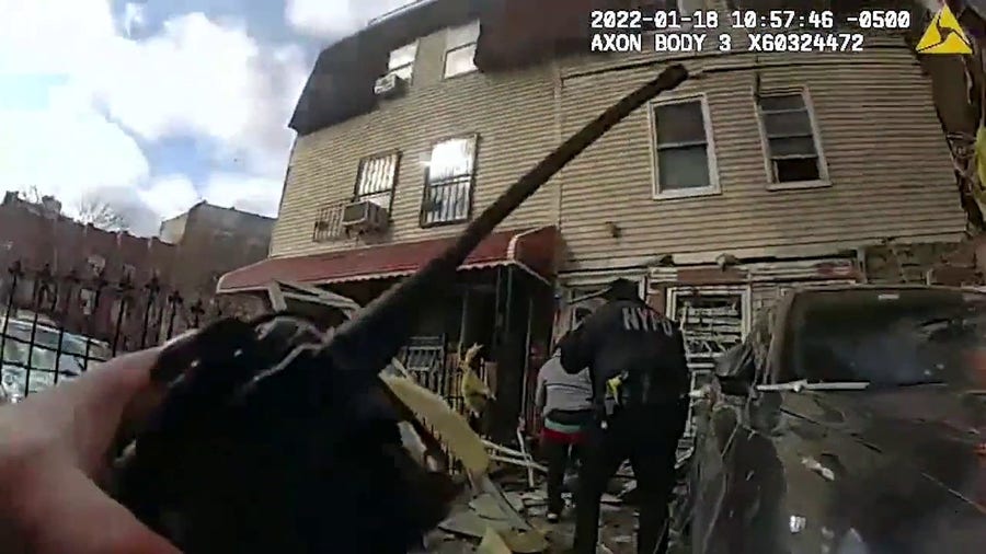 NYPD officers search for victims after a home exploded in the Bronx