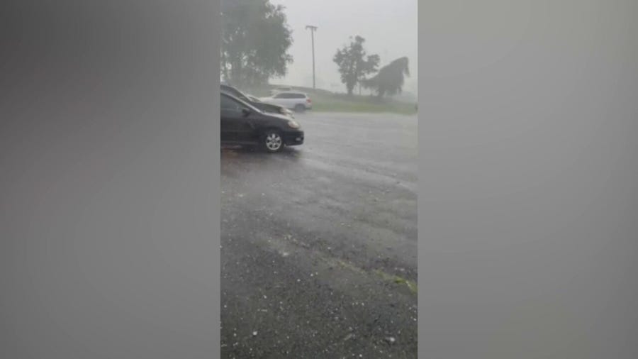 Hail bounces of vehicles in Tennessee parking lot