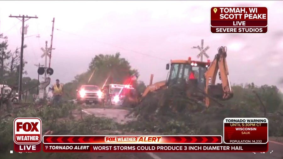 Crews remove downed trees from roads in Tomah, Wisconsin after tornado