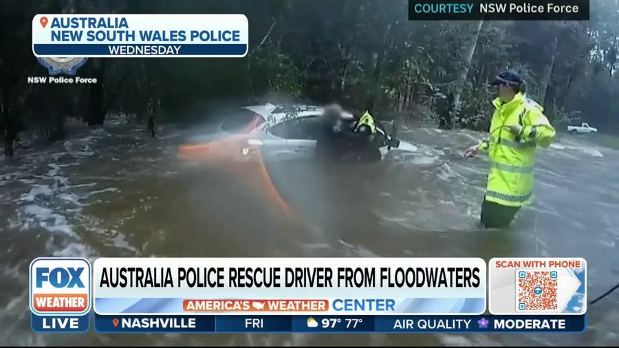 Australia police save trapped driver from floodwaters