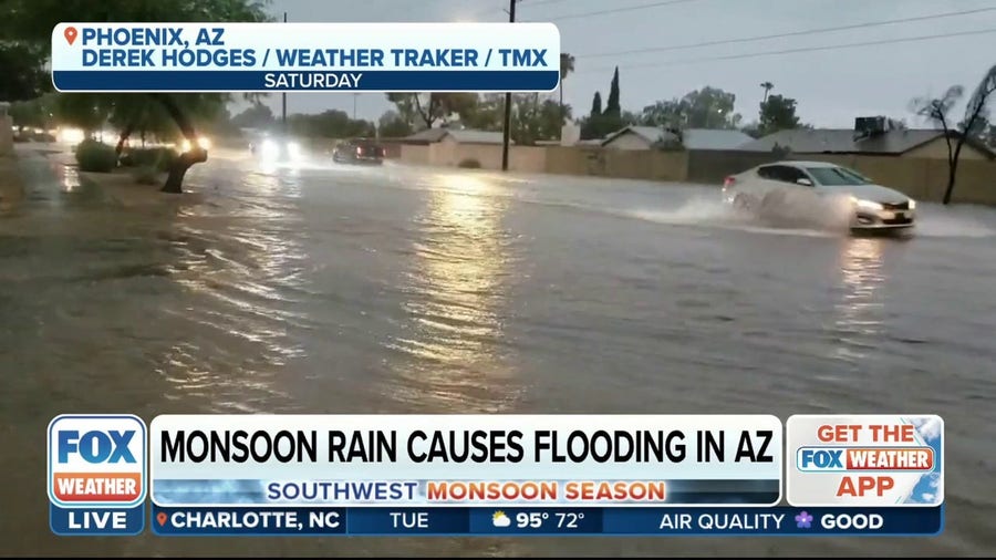 Cars plow through flooded roadways in Phoenix, AZ
