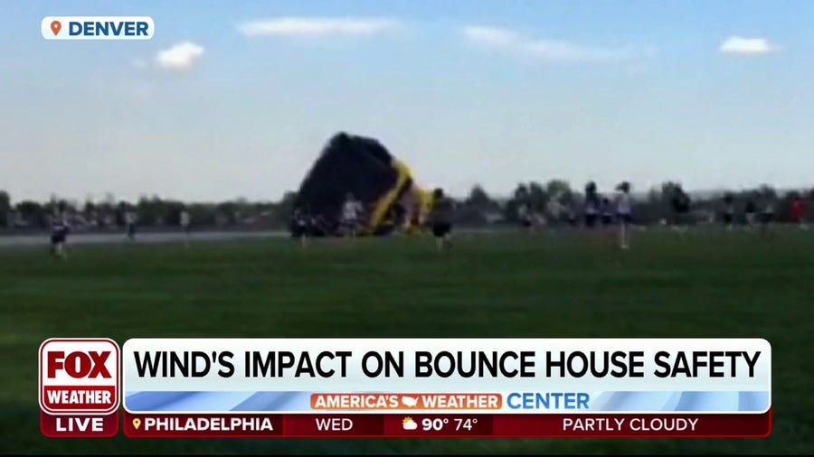 How does wind impact safety of bounce houses?
