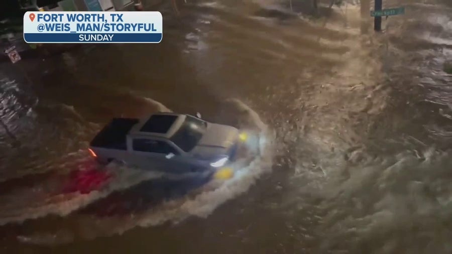 Drivers maneuver through flooded streets in Forth Worth, Texas