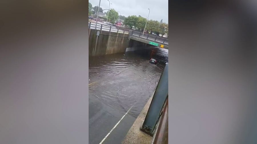 Car captured driving through flooded road under Rhode Island bridge