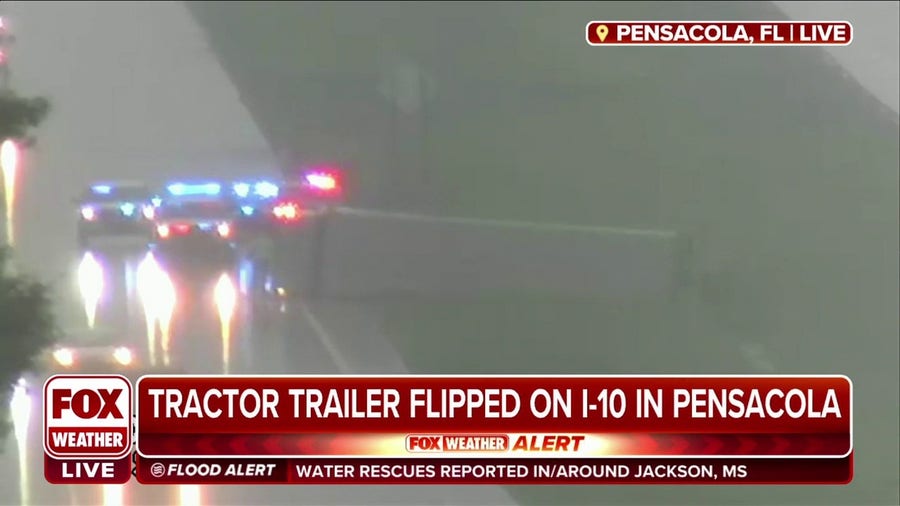 Tractor trailer flips over on rainy Pensacola, FL highway