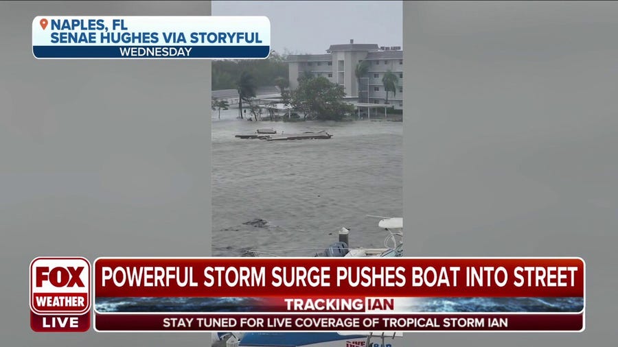 Powerful storm surge pushes boat into street in Naples, Florida