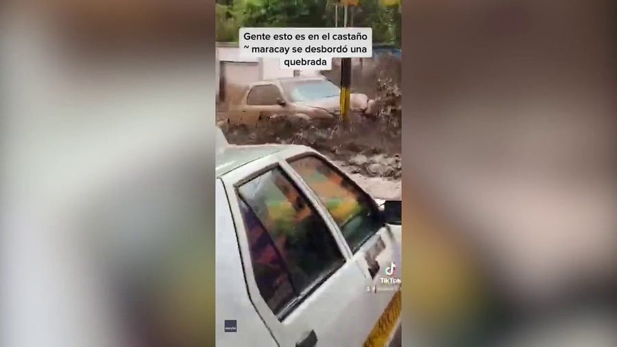 Car swept away by surging floodwater in Venezuela