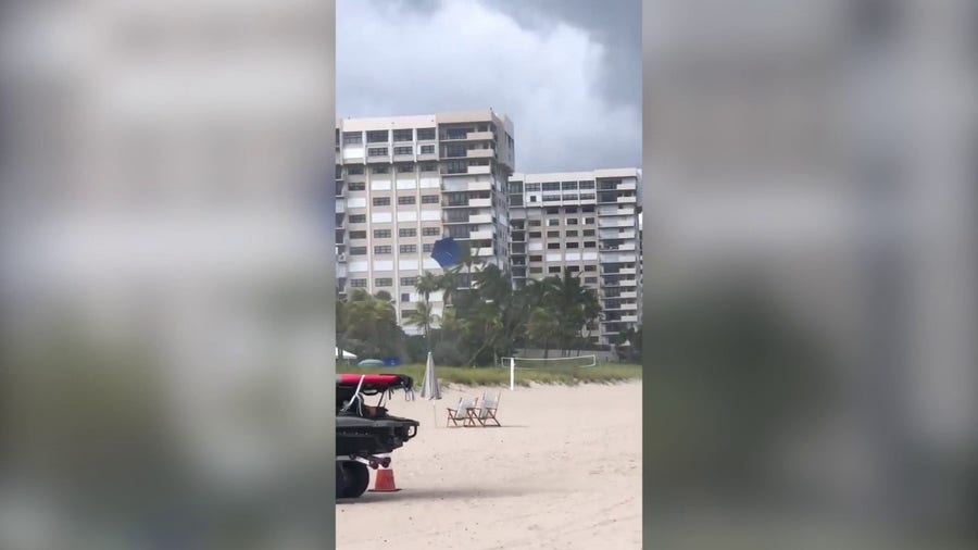 Waterspout sends beach umbrella flying along Florida beach