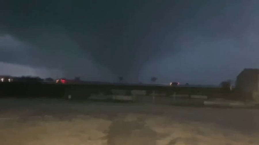 Lightning flashes as possible tornado swirls in North Texas