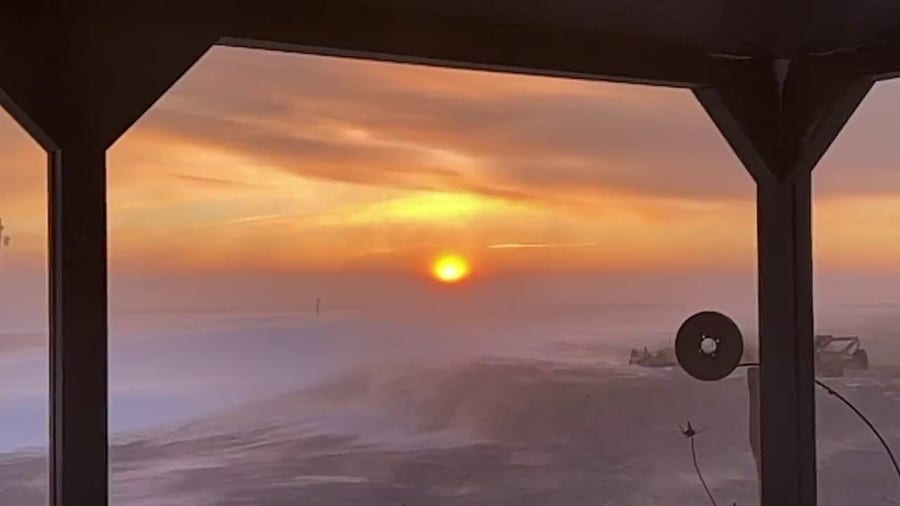 Sun rises as gusty winds blow snow across Colorado