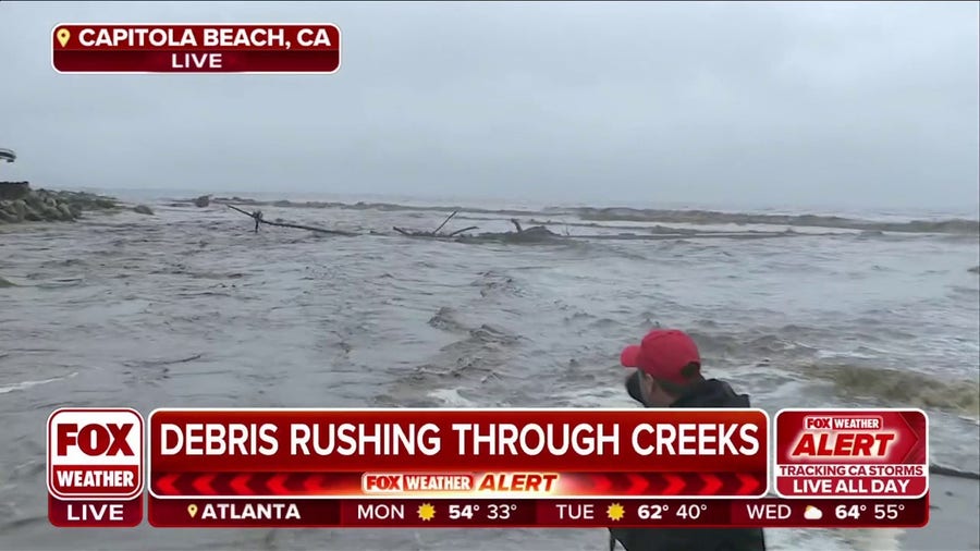 Debris rushing through Soquel Creek in Capitola Beach, CA