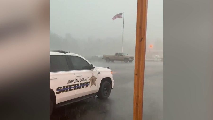 Storm whips American flag, pounds pavement in Alabama