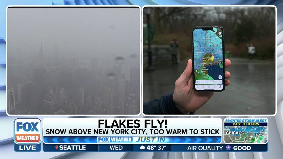 Snowflakes fly in New York City, too warm to stick