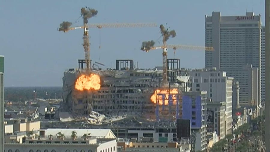 Explosions take down cranes swinging wildly in wind