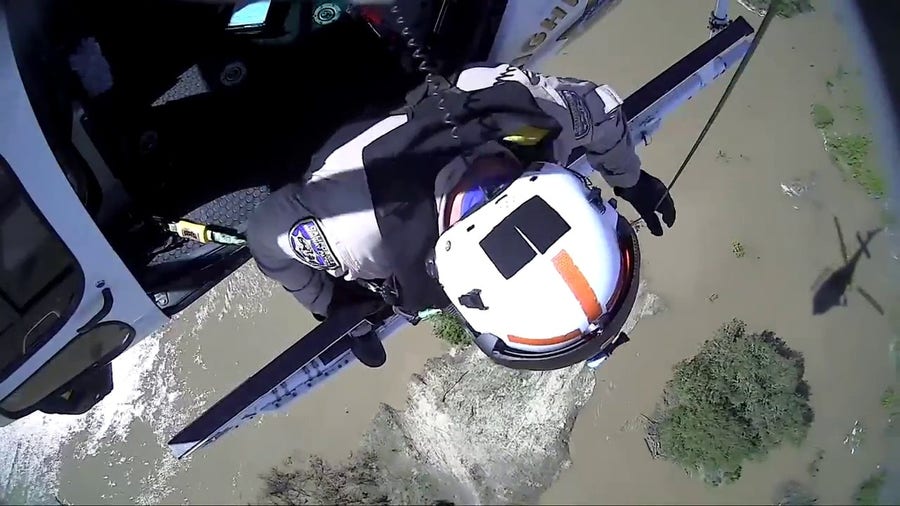 Man rescued from island after raging California river sweeps car away