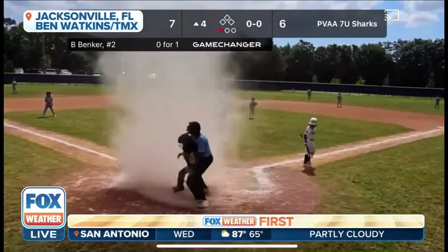 Dust devil swallows youth baseball player during game, umpire scoops him out