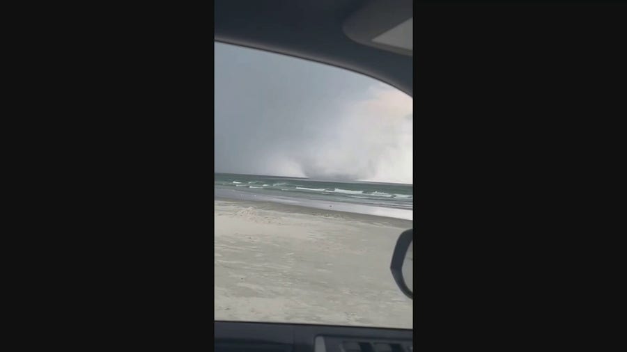 Couple captures tornado transitioning to waterspout